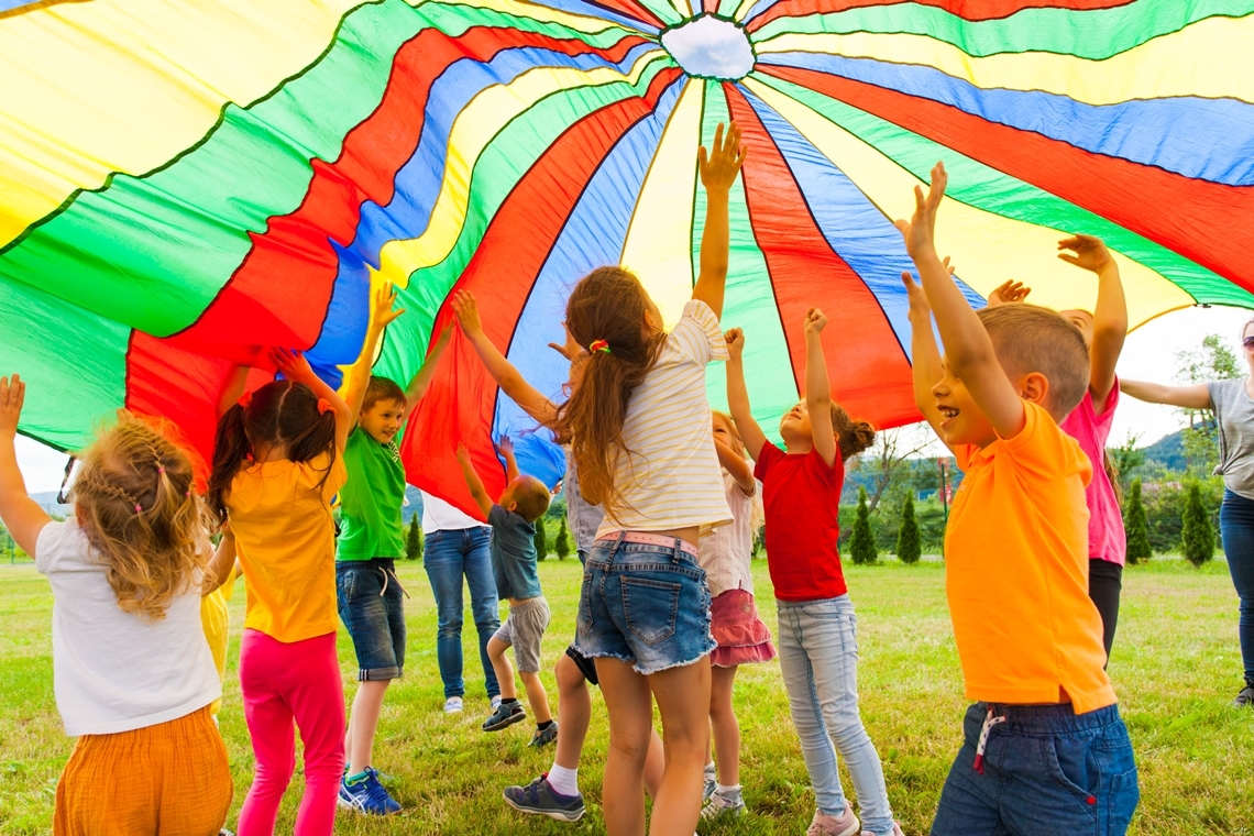 children playing with parachute