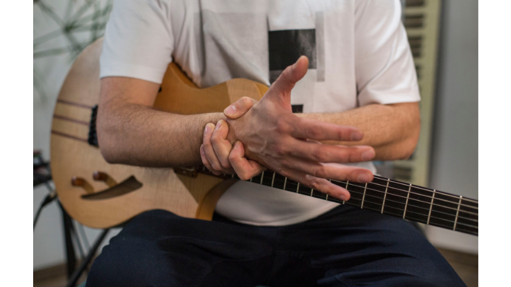 musician gripping hand