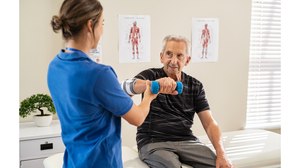 A clinician assists a patient with weight lifting