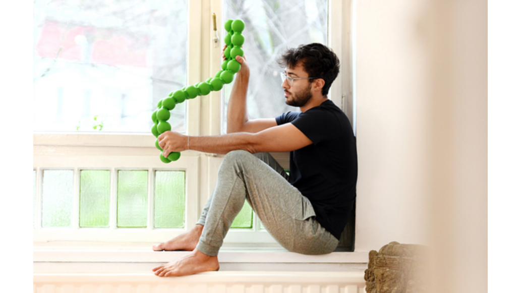 Man sits win windowsill with a SPINEFITTE twisting in his hands.R