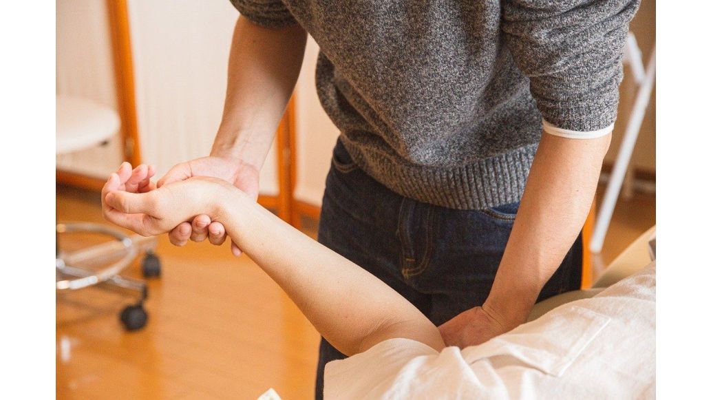 professional performing rehabilitation therapy on a patient's wrist