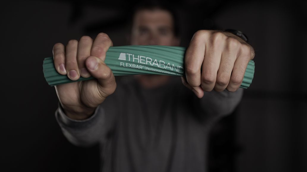 Man twisting a THERBAND product