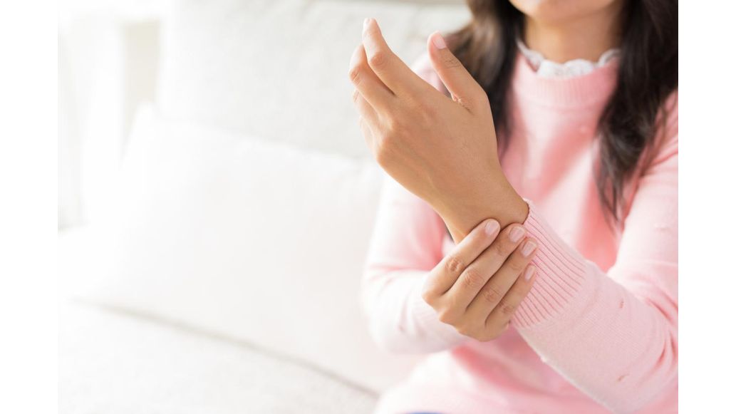 woman holding wrist in pain