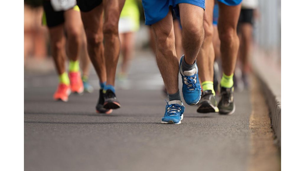 Group of 5k runners running on city road