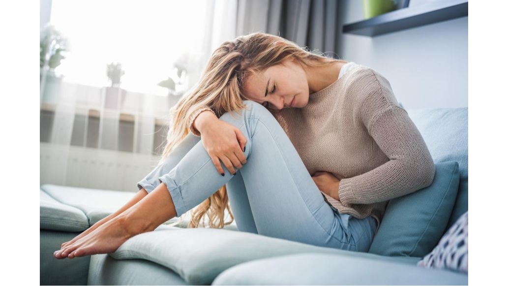 woman in pain on couch