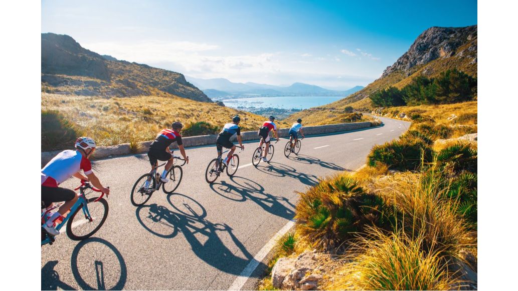 cyclists riding down a road