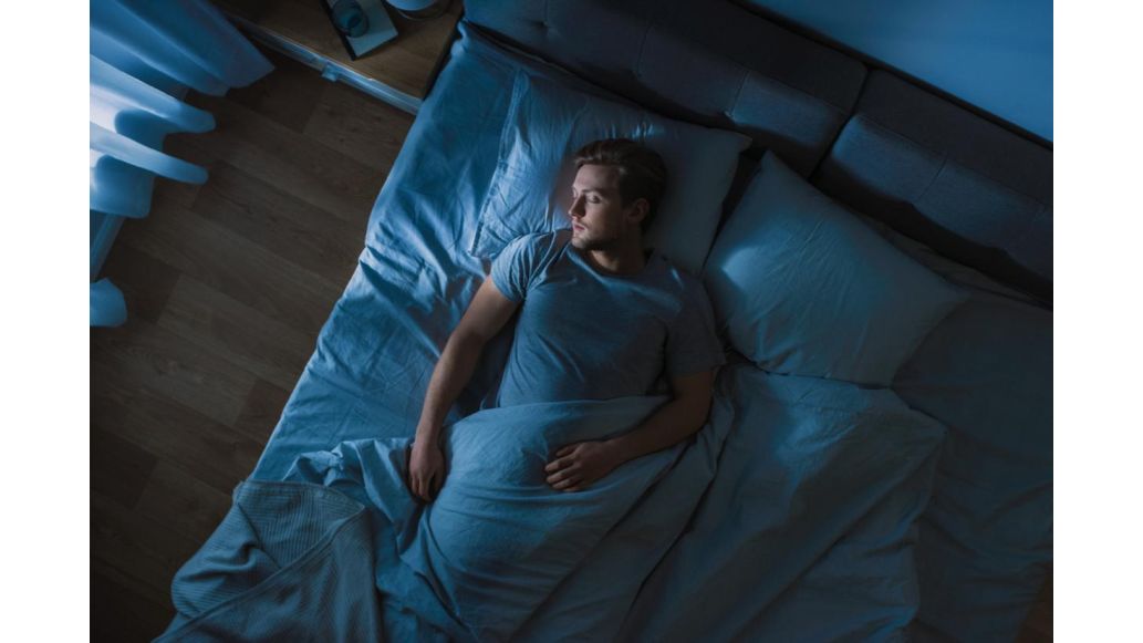 man sleeping in bed