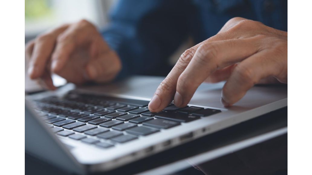 Man typing on computer keyboard