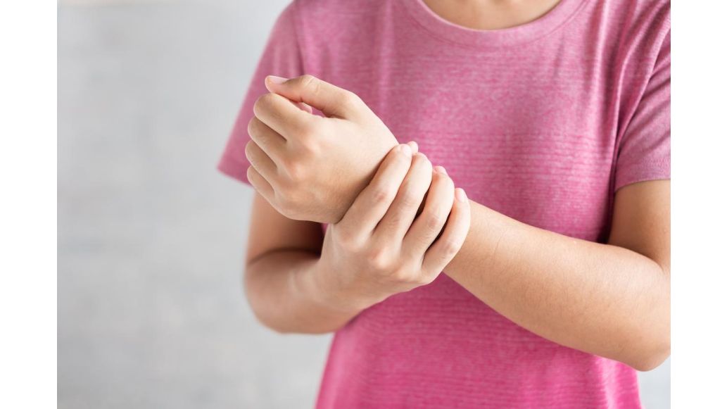 Woman holding her wrist in pain