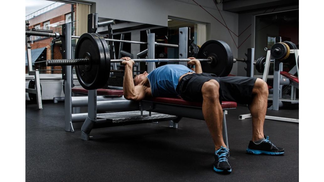 Man benching chest press in the gym