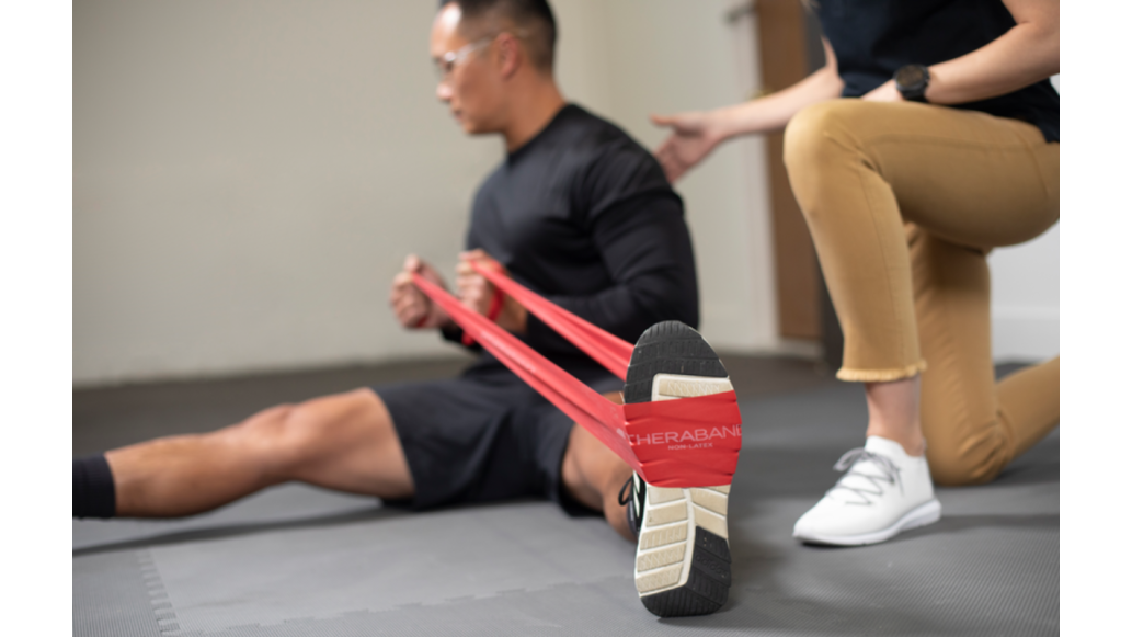 man stretching with THERABAND