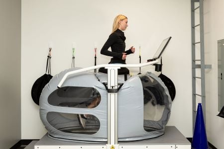 Woman running on treadmill in JPI clinic