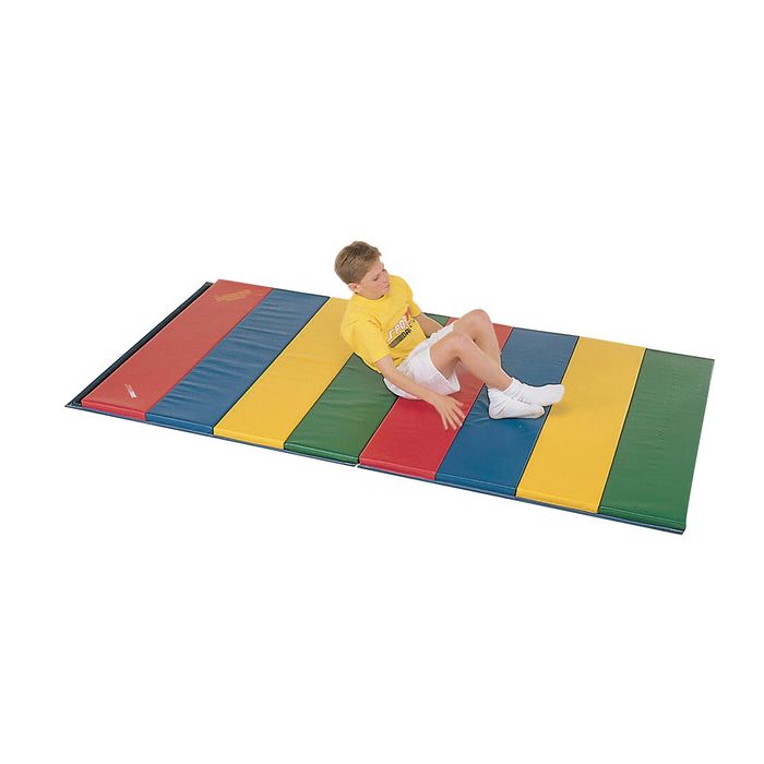 Child laying down on rainbow colored folding foam floor mat