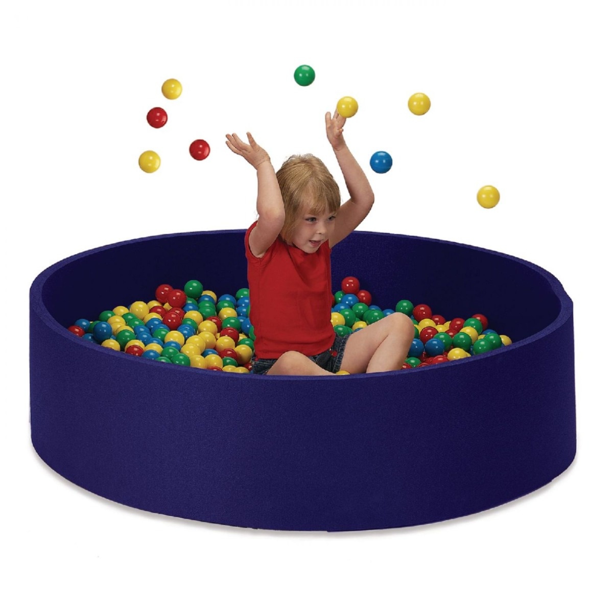 Child sitting in blue ball pit, joyfully tossing colorful balls into the air