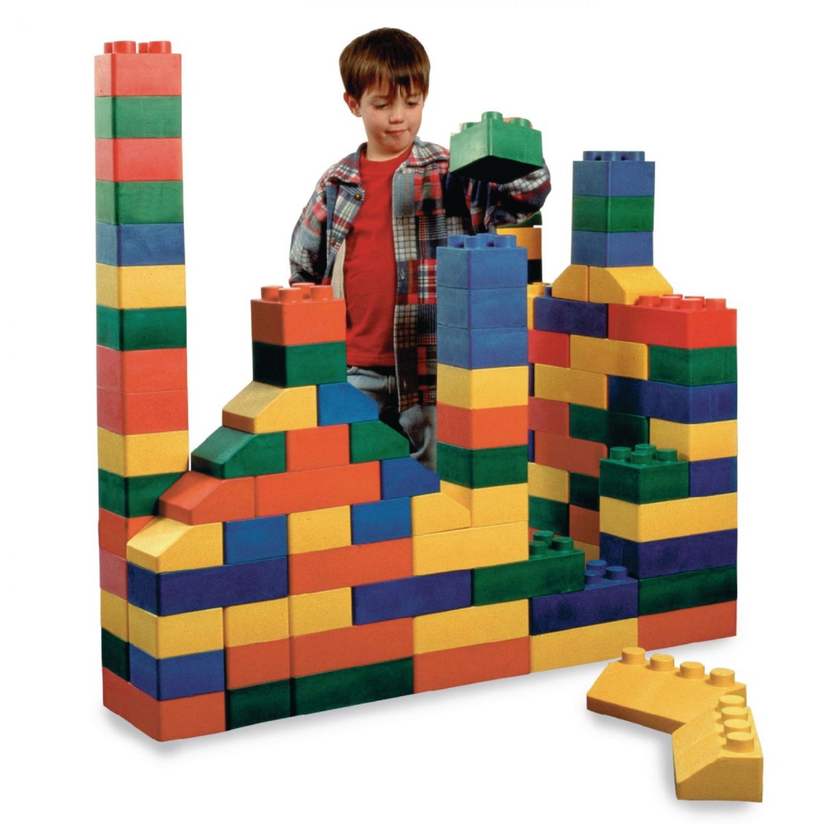Child stacking green block on top of tower of colorful Edu-Blocks in variety of shapes