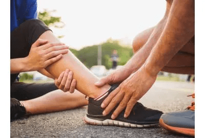 person holding hurt ankle
