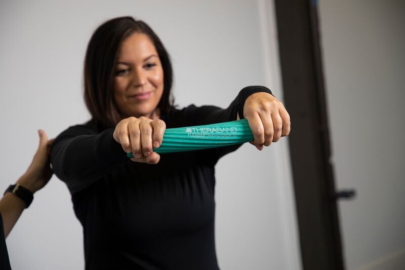 woman twisting green flexbar