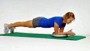 Person doing a plank core exercise on a TheraBand stability disc