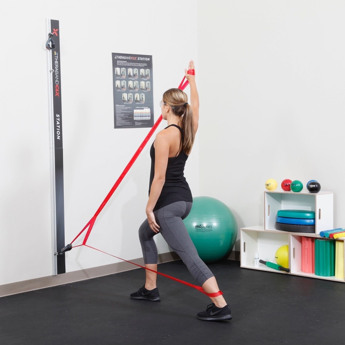 person using THERABAND wall station