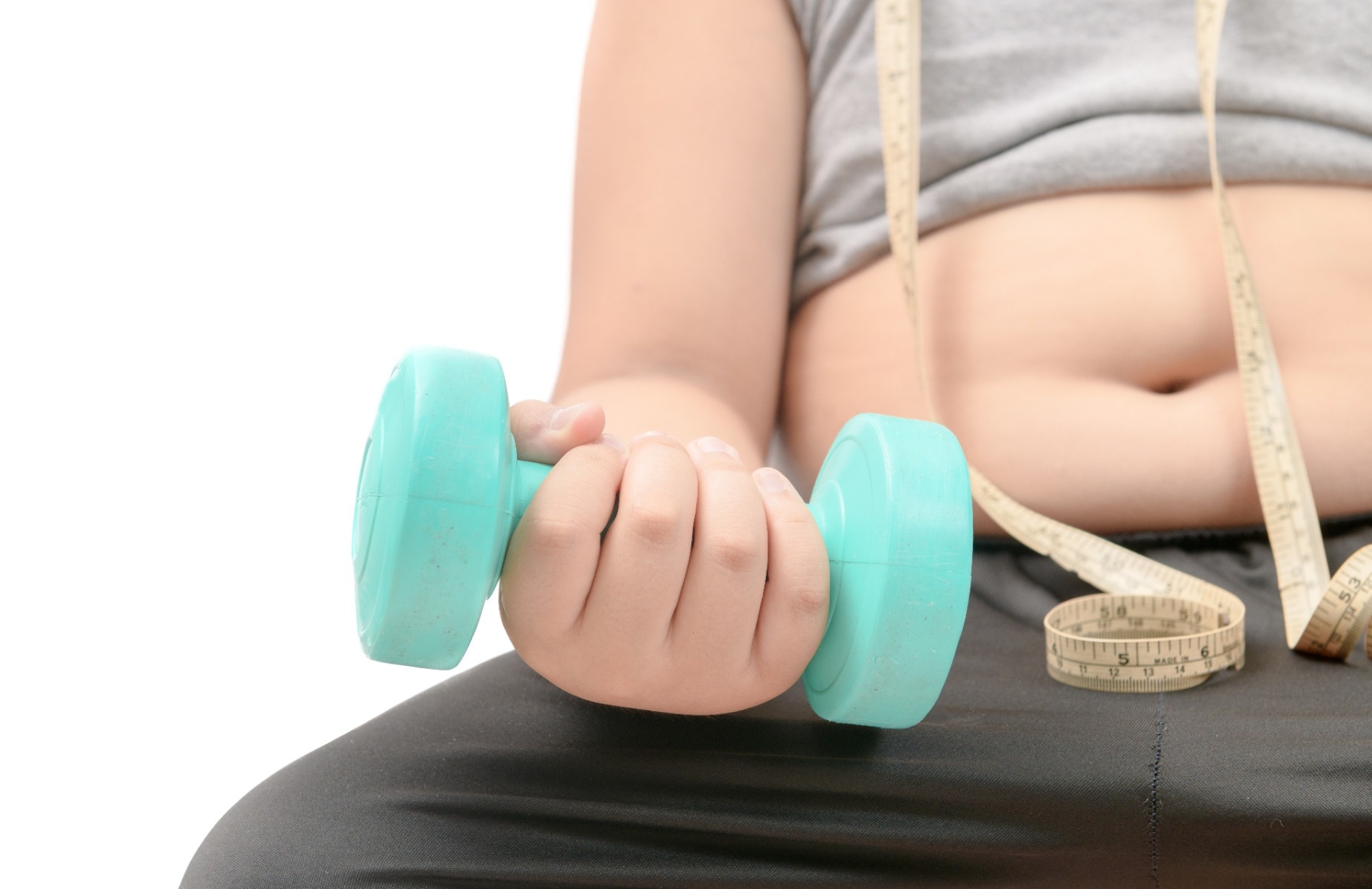 obese boy holding dumbbell