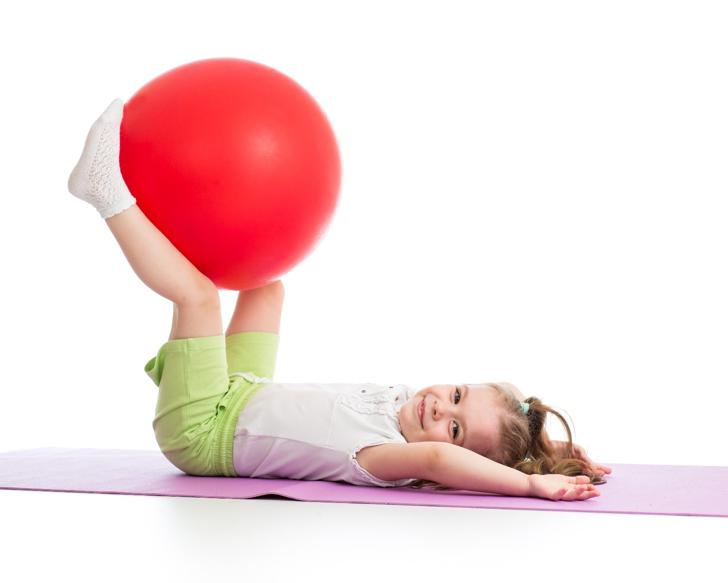 little girl doing core exercises on exercise ball