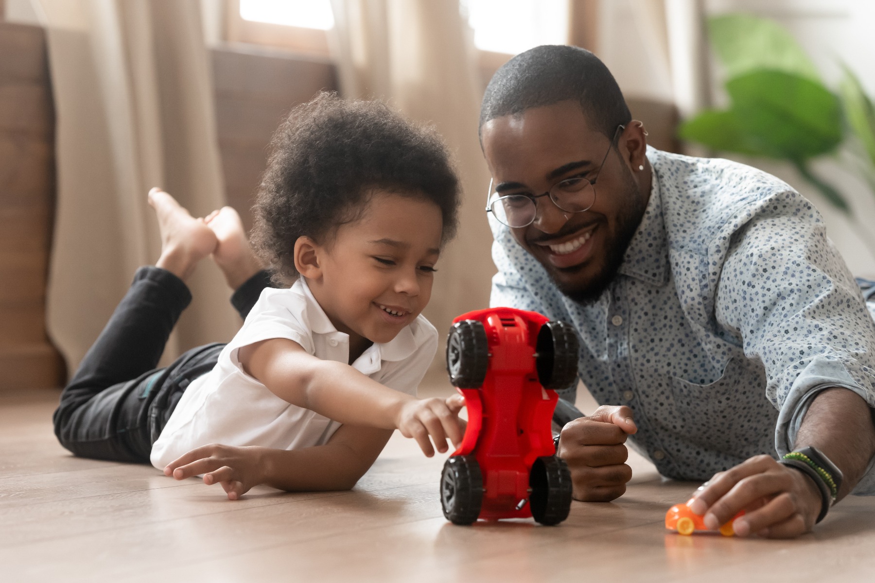 toddler playing with father