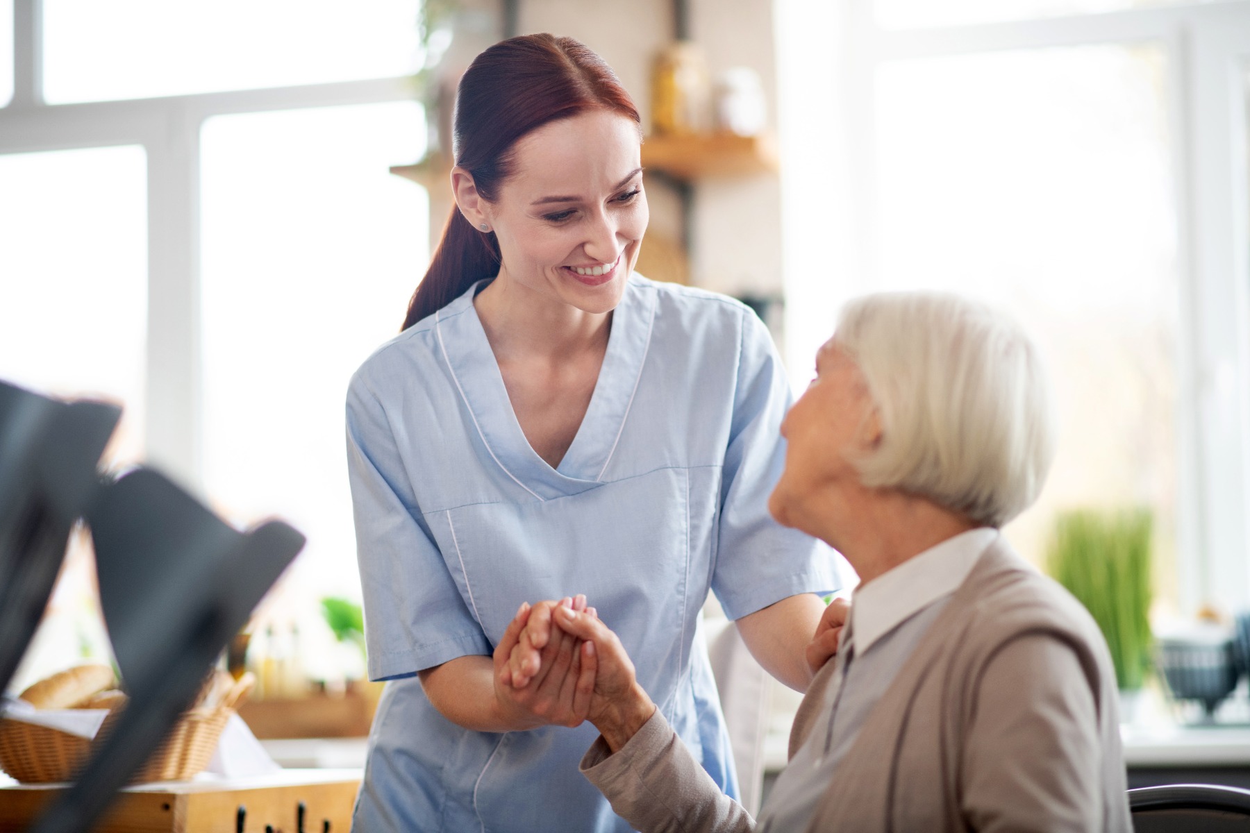 nurse helping elder woman