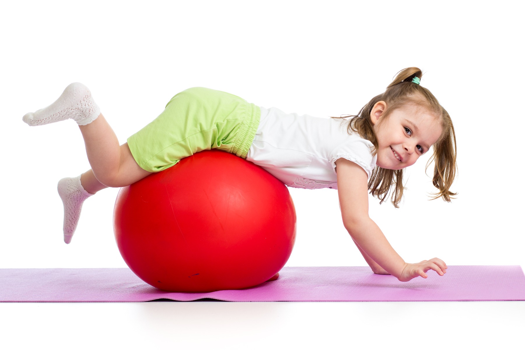 little girl doing core exercises on exercise ball