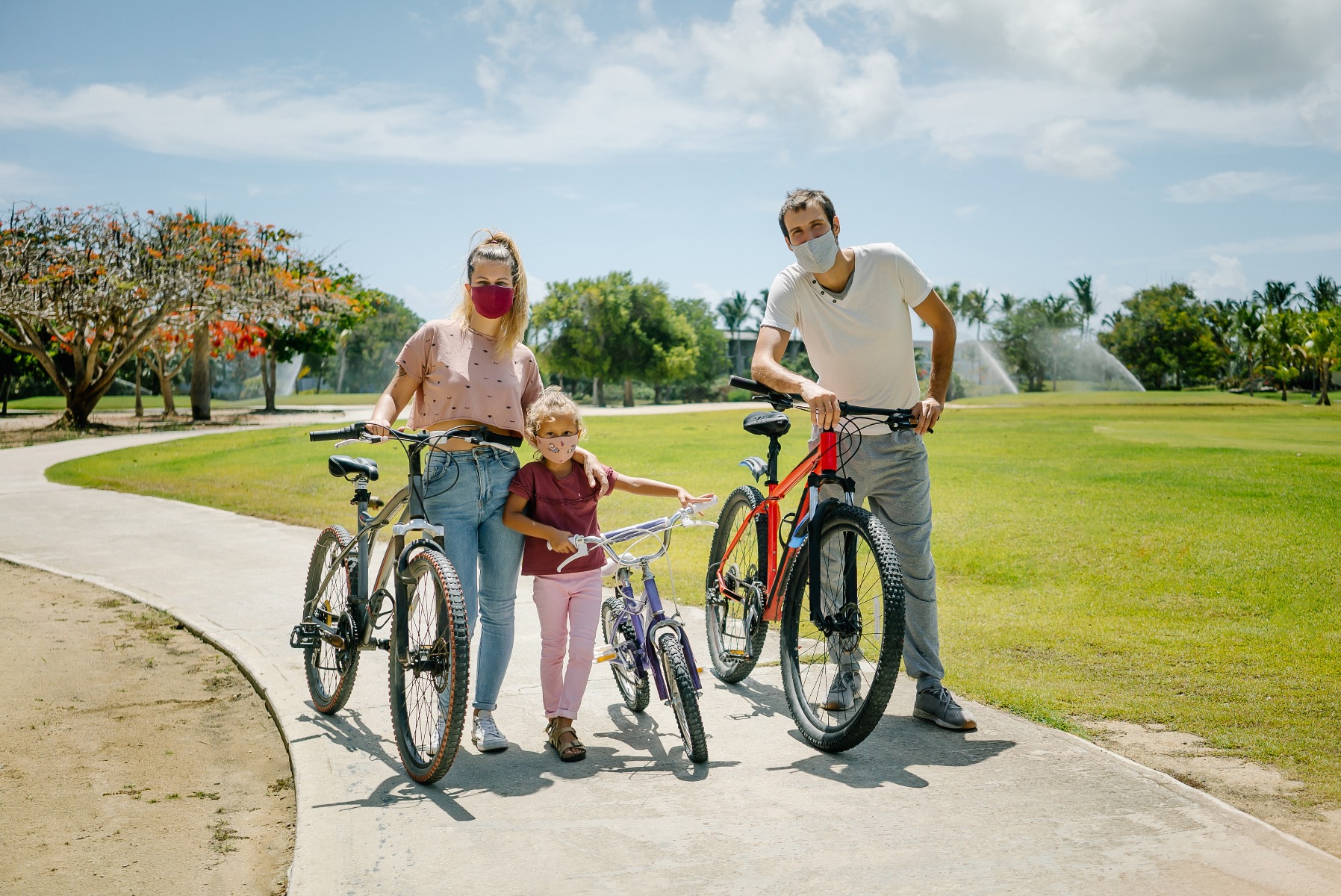 family biking with masks