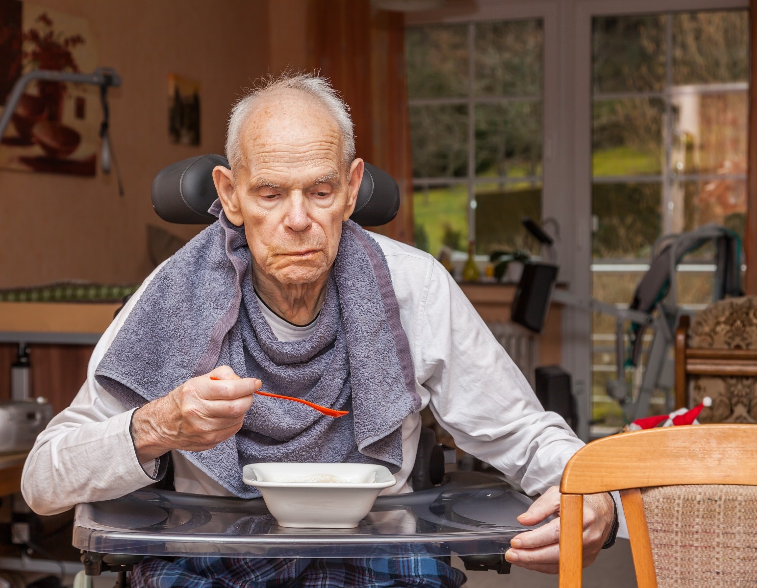 Senior man eating with assistance of dining aid