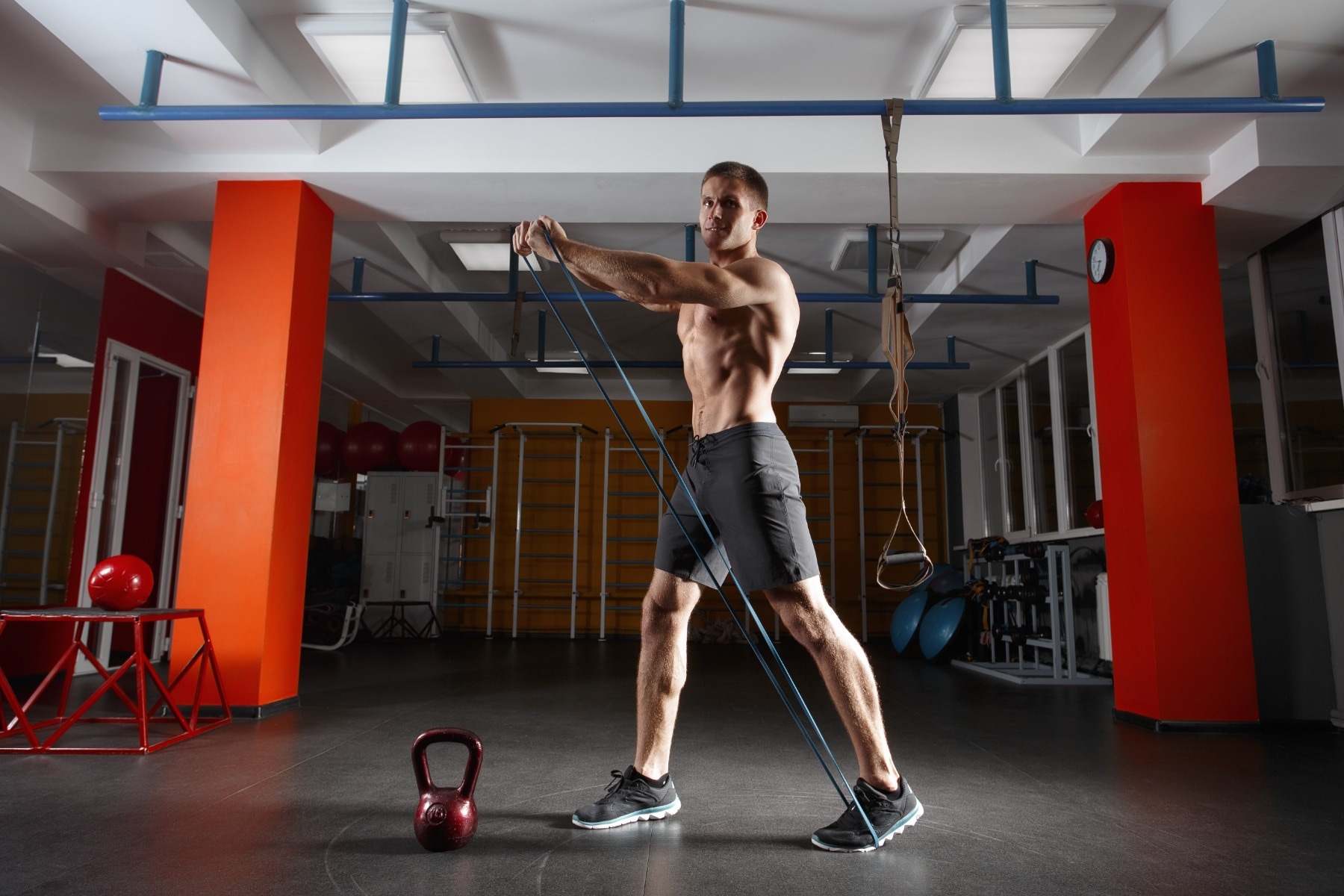 man using theraband in gym