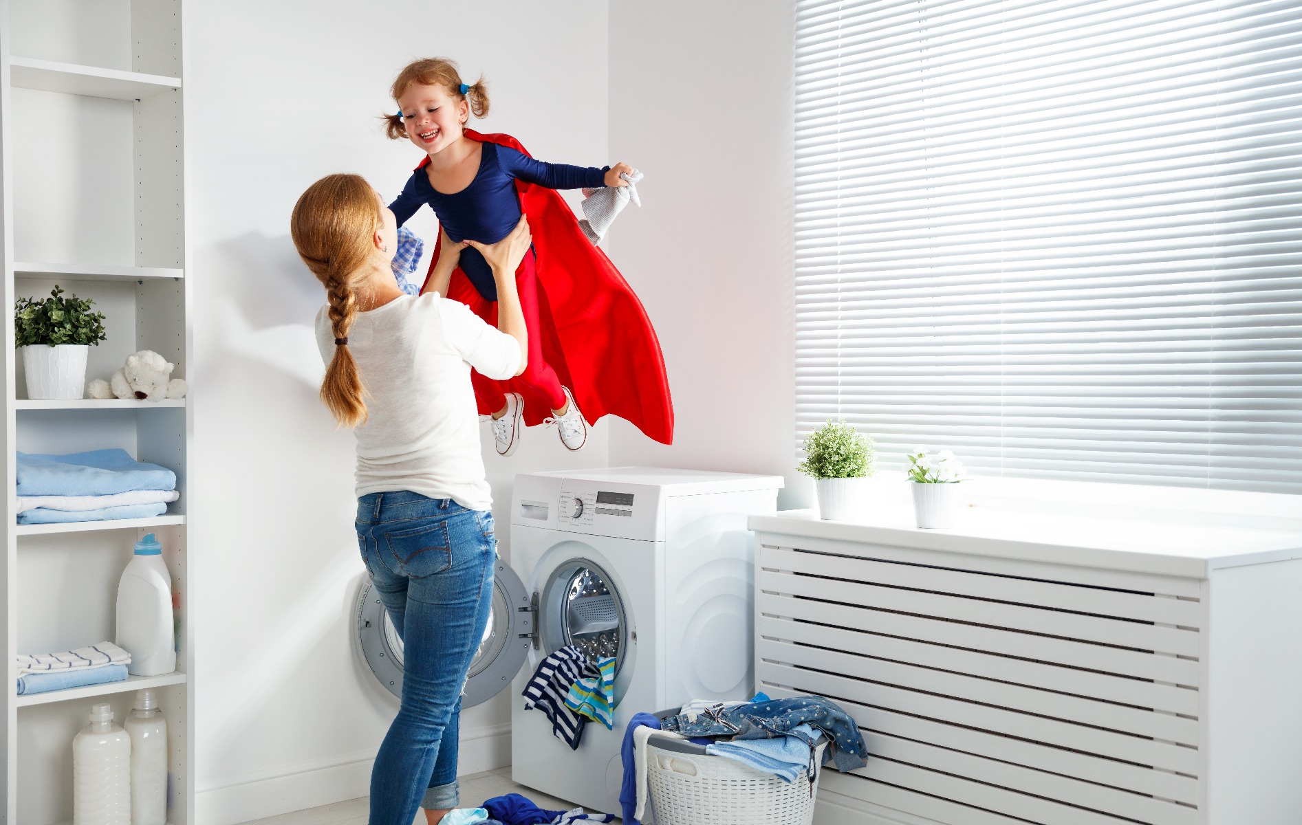 mother holding toddler in air