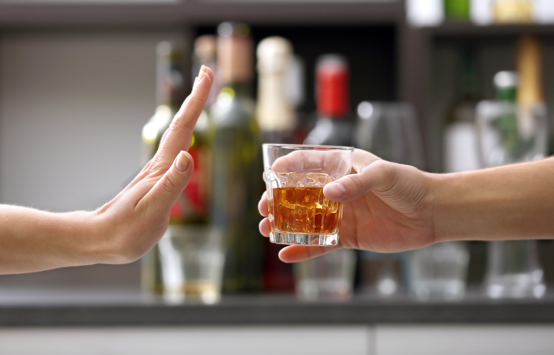 Person saying no to an alcoholic beverage being handed to them