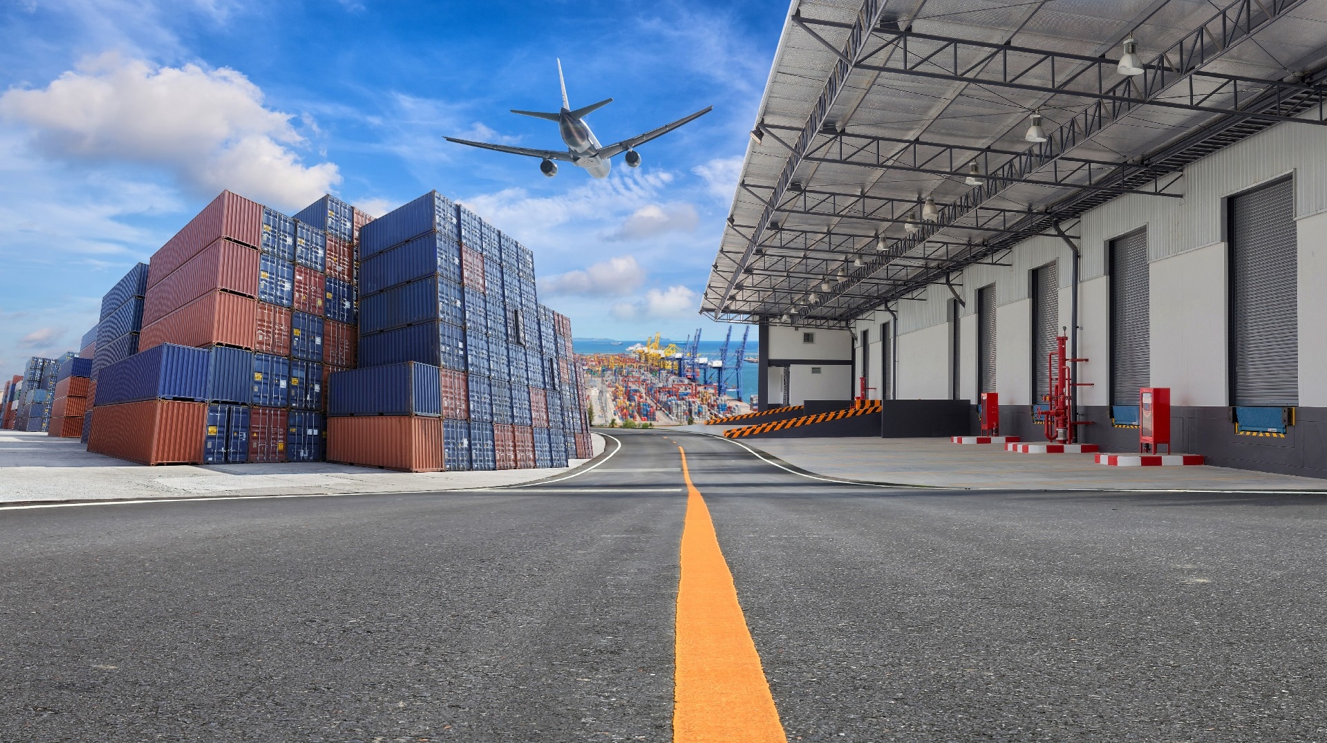 Plane flying over shipping containers and logistics facility