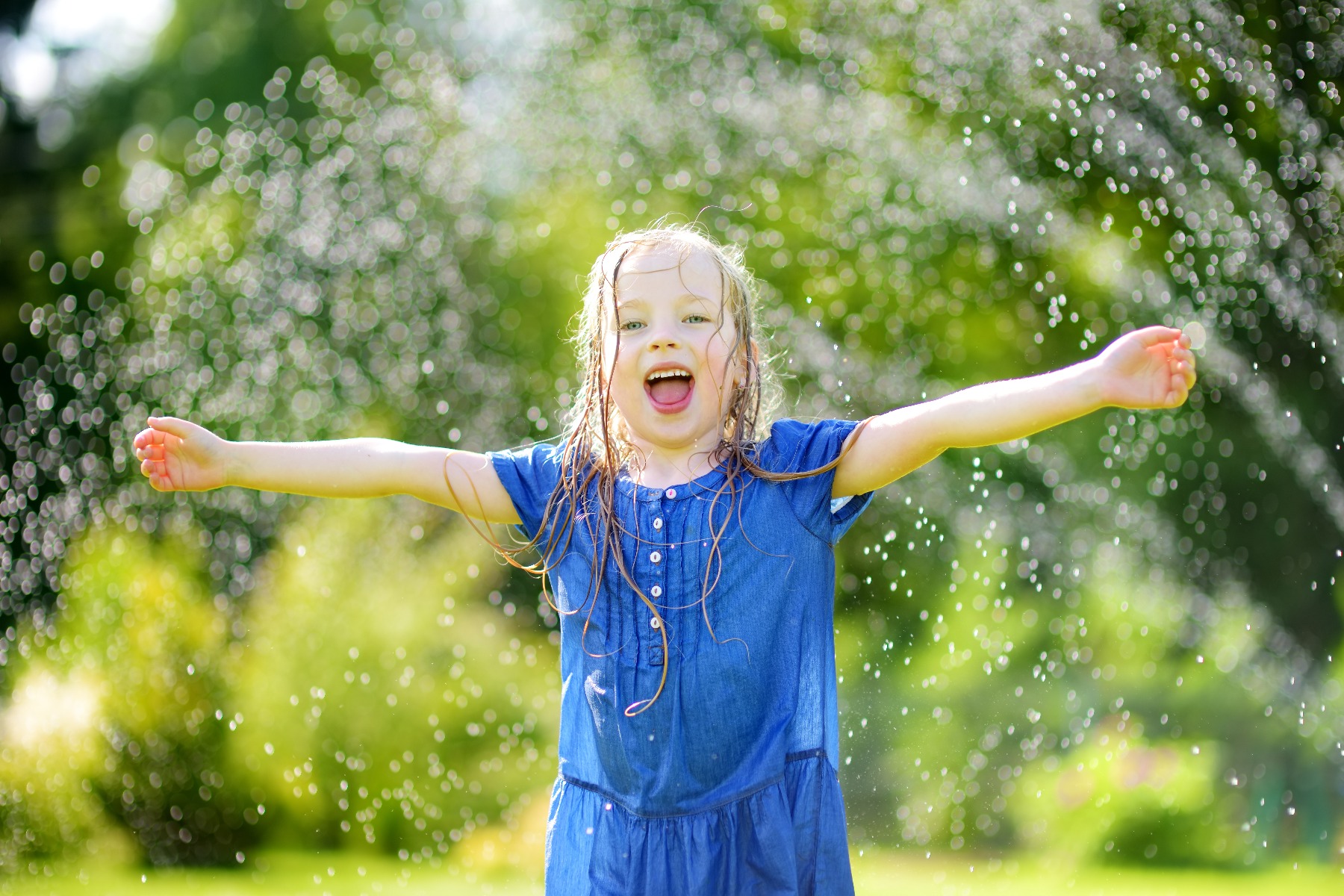 kid in sprinkler