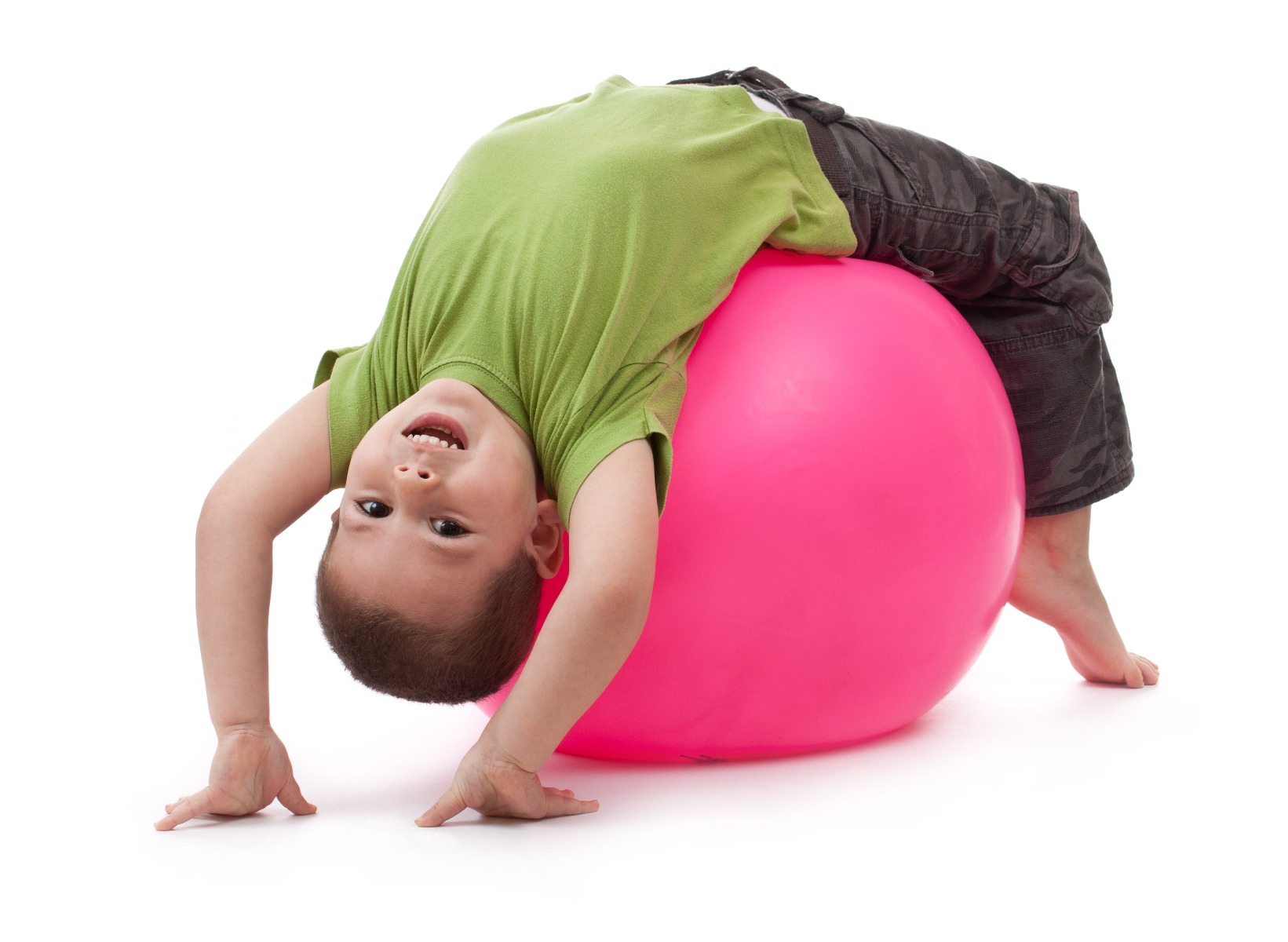 little boy doing core exercises on exercise ball