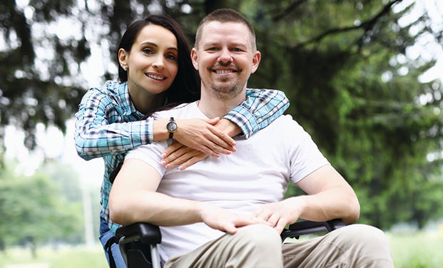 veteran in wheelchair with spouse